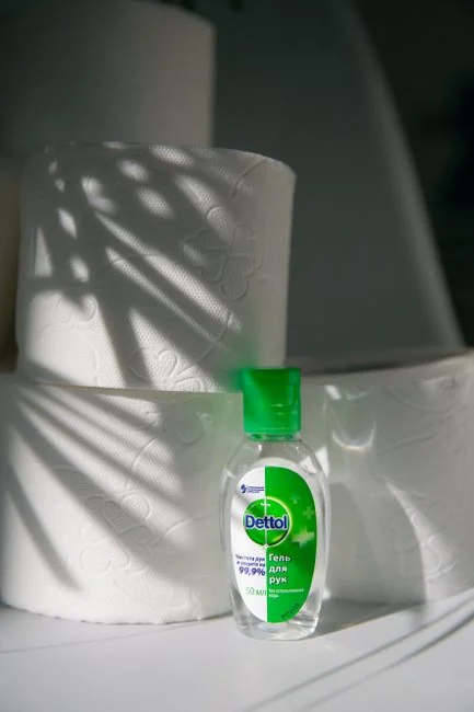 why-choose-us A woman carefully covers a sofa with protective wrapping while she packs boxes in a bright room.